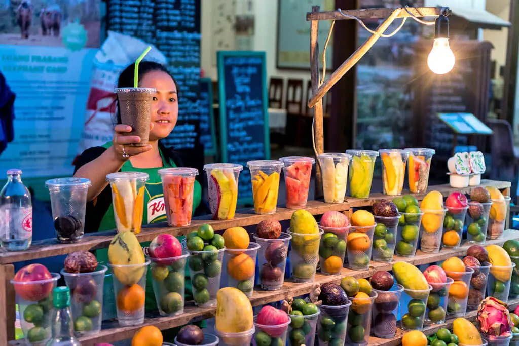 Eine Laotin verkauft Fruchtshakes auf dem Nachtmarkt in Luang Prabang